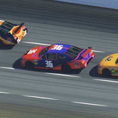 Cars racing around a speedway